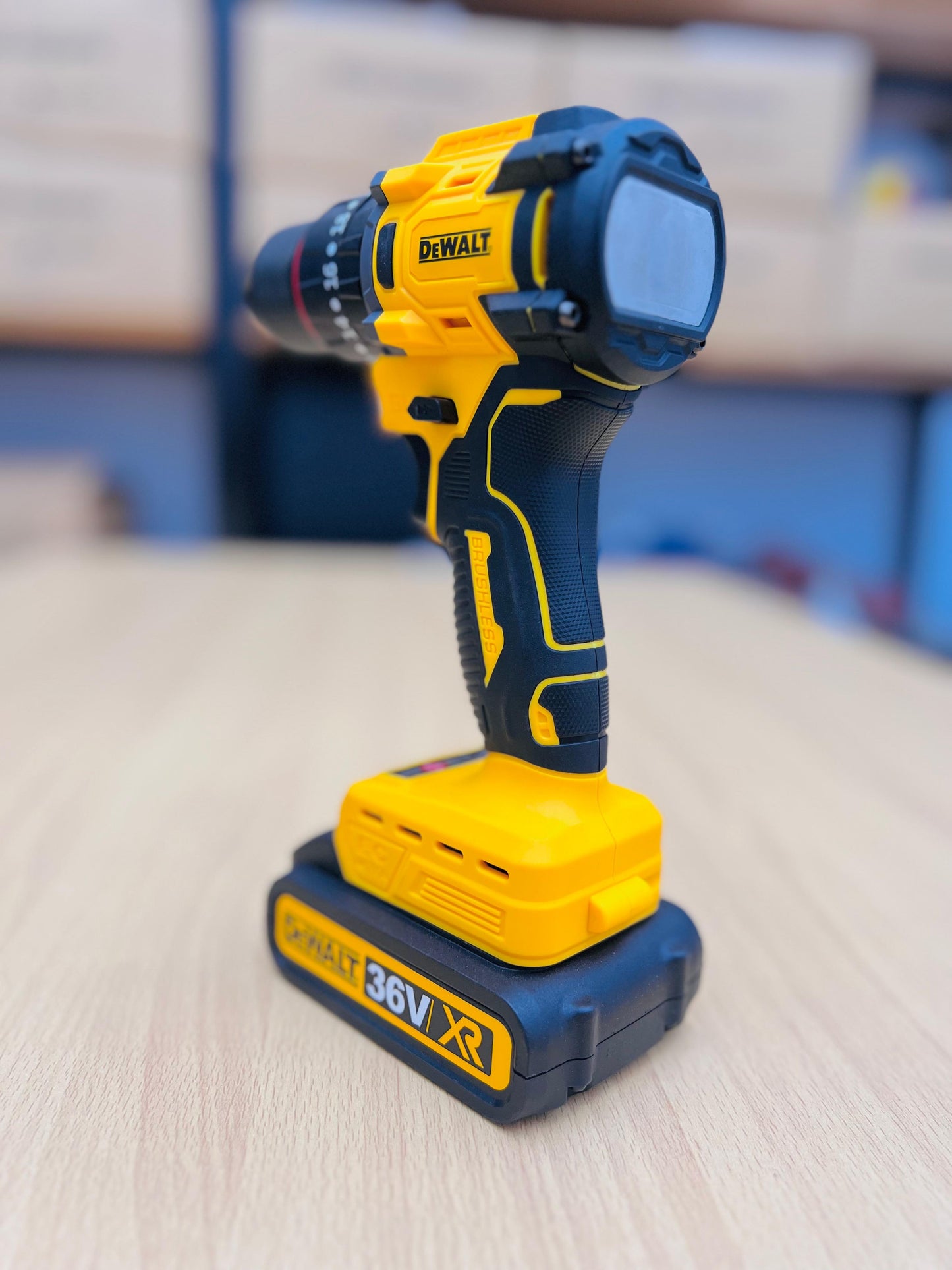 DeWalt cordless drill on a wooden surface with a blurred background