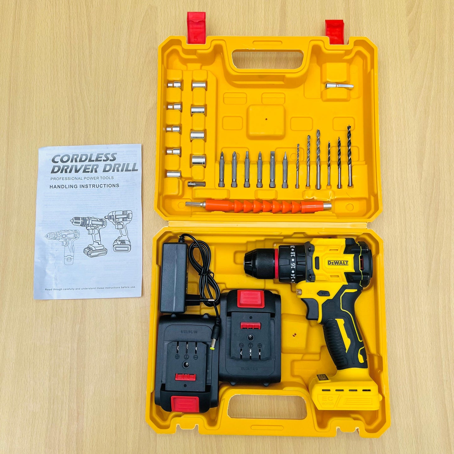Dewalt cordless driver drill set with accessories and manual on a wooden surface