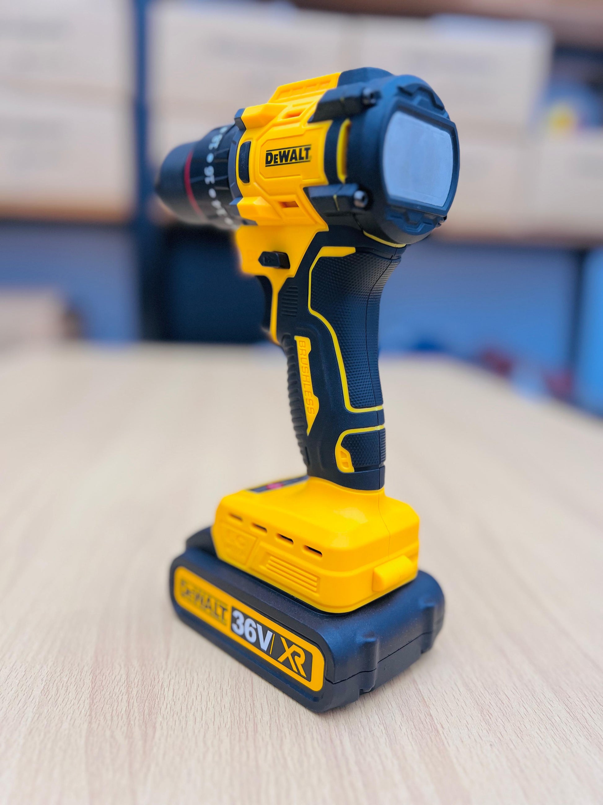DeWalt cordless drill on a wooden surface with a blurred background